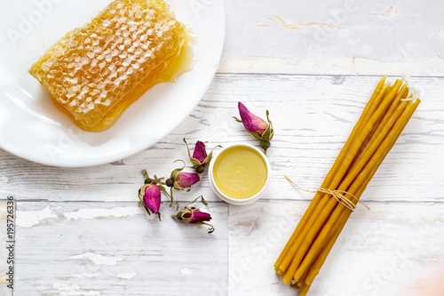 Fotografie, Obraz organic tasty honeycomb, honey lip balm, pink wild roses and natural candles