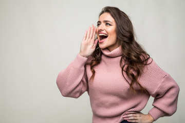 Wall Mural - Young beauty woman shout and scream using her hands as tube, studio shoot isolated on white background