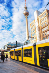 Wall Mural - Running tram on Alexanderplatz with television tower in Berlin