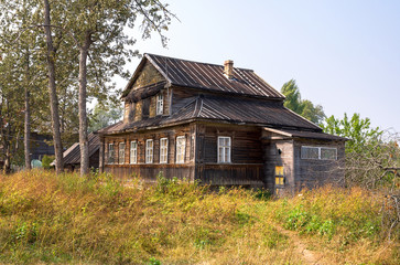 Wall Mural - Big old wooden house in russian village in summer day