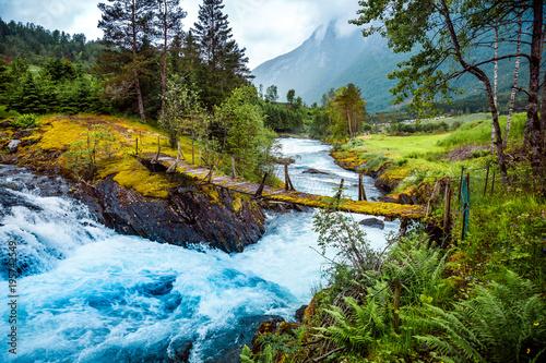 Fotografía Suspension bridge over the mountain river, Norway.