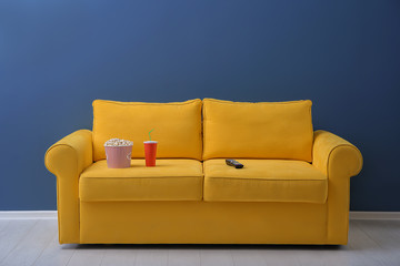 Wall Mural - Comfortable sofa with popcorn, drink and remote control in home cinema. Watching movie