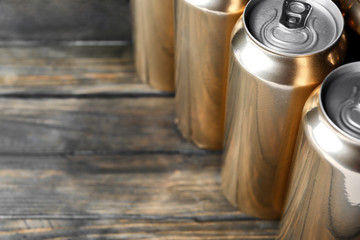 Poster - Cans of beer on wooden background, closeup