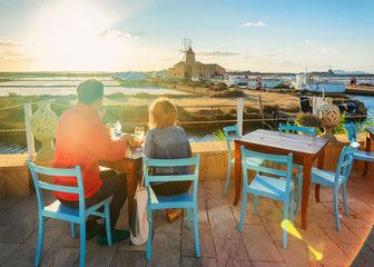 Sticker - People at street restaurant at salt evaporation pond Marsala Sicily