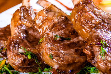 Wall Mural - Rack of lamb with vegetables and herbs on white plate