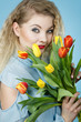 © Voyagerix - Woman holding bouquet of tulips flowers