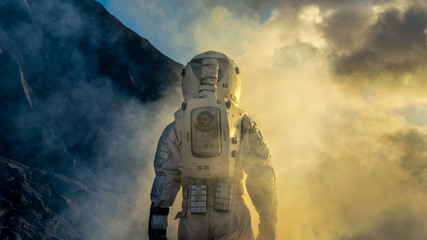 Wall Mural - courageous astronaut in the space suit explores mysterious alien planet covered in mist. adventure. 