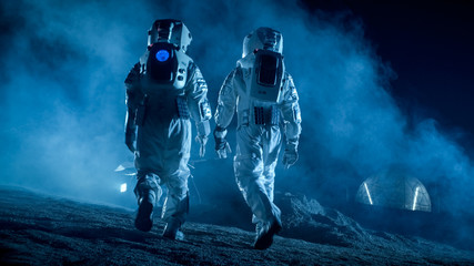 Wall Mural - shot of two astronauts in space suits on alien planet walking toward rover and geodesic dome. high-t