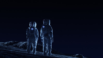 Wall Mural - two astronauts in space suits stand on the alien planets observing extraterrestrial terrain. space t