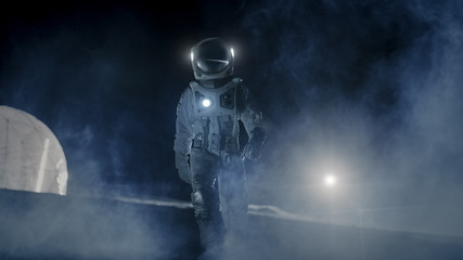 Wall Mural - courageous astronaut in the space suit with flashlight explores mysterious alien planet covered in m