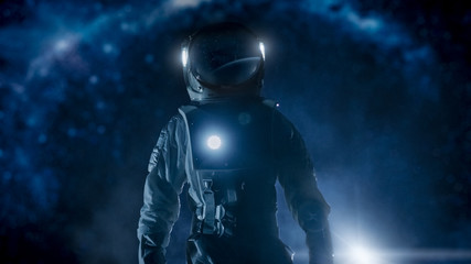 Wall Mural - courageous astronaut in the space suit with flashlight explores mysterious alien planet. the milky w