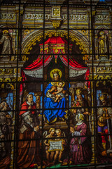 Painted glass with Mary and baby Jesus in the interiors of Saint Nicholas Church, Ghent, Belgium