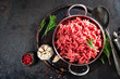 Cooking mince. Raw ground veal meat with ingredients for cooking on black kitchen table. Fresh minced meat, top view