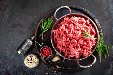 Canvas Print - Cooking mince. Raw ground veal meat with ingredients for cooking on black kitchen table. Fresh minced meat, top view