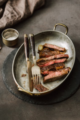 Poster - Slices juicy roast beef steak on vintage frying pan close up