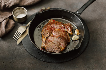 Wall Mural - Juicy beef steak on a vintage cast-iron frying pan