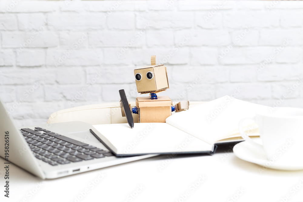 The robot writes with a pen and looks at the computer monitor. Artificial Intelligence