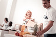 © zinkevych - Be careful. Delighted male person bowing head and taking pineapple while packing box