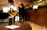 Fototapeta  - a glass of white wine on a table