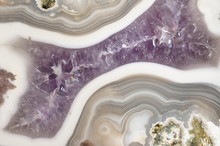 Closeup Of A Polished Banded Agate Geode Filled With Purple Amethyst Quartz Crystals.