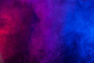 Violet and blue smoke or flame texture on a black background. Texture and abstract art