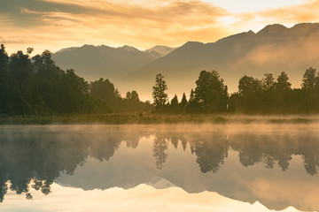 Beautiful mirror water Matheson lake in morning, New Zealand natural landscape background