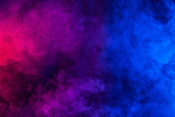 Violet and blue smoke or flame texture on a black background. Texture and abstract art