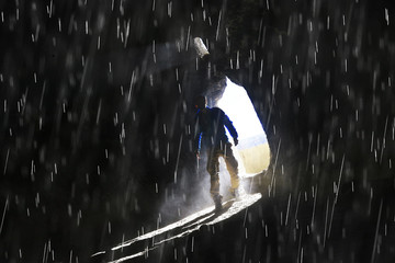 entrance to the cave, a male traveler stands in the rays of light at the exit of the cave, historical ruins, the concept of treasure search