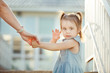 © Ilshat - girl holding mother's hand and waves hand turning back