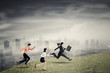© Creativa Images - Three business people running speed on the hill