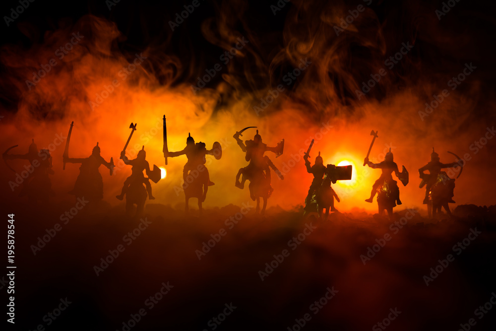 Medieval battle scene with cavalry and infantry. Silhouettes of figures as separate objects, fight between warriors on dark toned foggy background. Night scene. - obrazy, fototapety, plakaty 