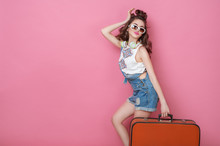 Happy Beauty Woman Traveler Holding A Vintage Suitcase On Road. Fashion People Lifestyle Travel Concepts. Cute Glamour Girl In Sunglasses With Curly Hair Posing In Studio.