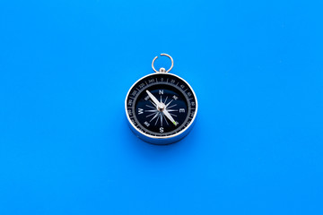 Wall Mural - Compass on blue background top view copy space