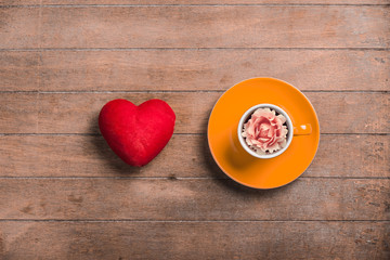 Wall Mural - Cup of tea with rosebud in it and heart shape toy