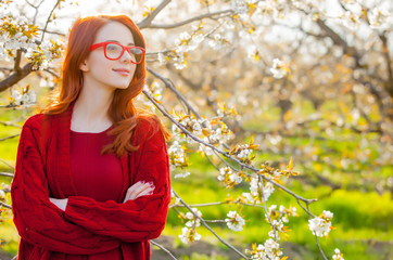 Poster - girl in red clothes in blossom cherry garden