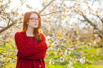 Poster - girl in red clothes in blossom cherry garden