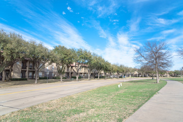 Wall Mural - Exterior view of typical apartment near public park in Irving, Texas, USA. Concrete trail for walking, jogging, biking.