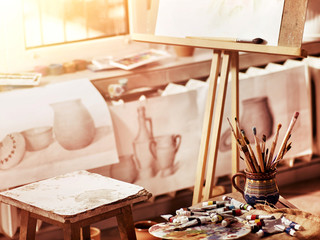 Authentic paint brushes still life on table in art class school as drawing course. Group of brush in clay jar. Quiet environment for creativity. Sale of artistic goods.