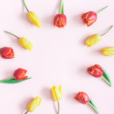 Fototapeta Tulipany - Flowers composition. Frame made of tulip flowers on pink background. Flat lay, top view, copy space
