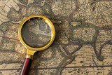 Fototapeta Mapy - Retro magnifier with old map