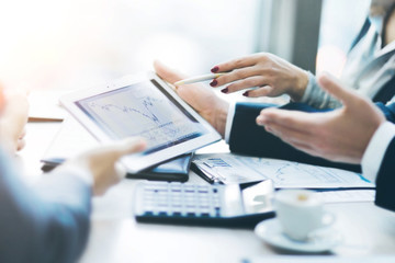 Image of human hand pointing at touchscreen, working environment at meeting