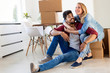 © NDABCREATIVITY - Young couple unpacking cardboard boxes at new home moving in concept