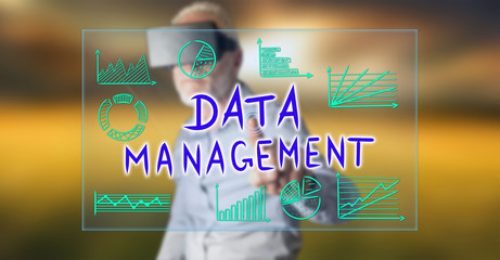 Wall Mural - man wearing a reality virtual headset touching a data management concept on a touch screen