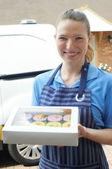 Wall Mural - Female Baker Making Home Delivery Of Cupcakes