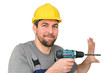 © industrieblick - lächelnder Handwerker/ Bauarbeiter in Berufsbekleidung mit Bohrmaschine - Freisteller weißer Hintergrund isoliert // smiling craftsman/construction worker in working clothes with drilling machine