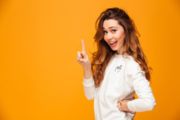 Sticker - Happy brunette woman in sweater posing with arm on hip