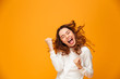 © Drobot Dean - Happy screaming brunette woman in sweater rejoices with closed eyes