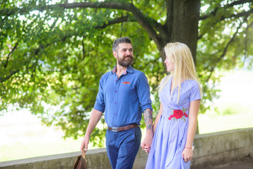 Wall Mural - Romantic couple concept. Bearded man walks with his girlfriend.