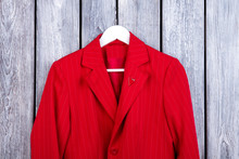 Red Suit Jacket Collar Close Up. Top View, Wooden Surface Background.