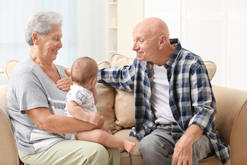 Poster - Senior couple with their little grandchild resting at home